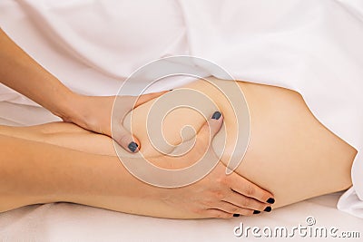 Close-up Master masseur performs anti-cellulite massage for girl. Procedure of manual anti-cellulite massage of the Stock Photo