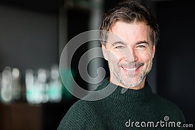 Close Up Of A Mature Man Smiling At The Camera.Hotel room Stock Photo