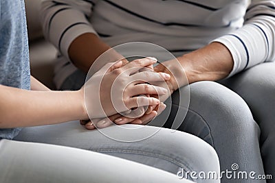 Close up of mature mom and daughter holding hands Stock Photo