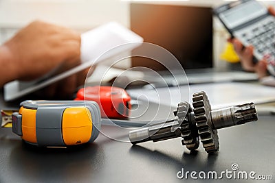 Close Up mechanical gear parts on office desk with engineers working background Stock Photo