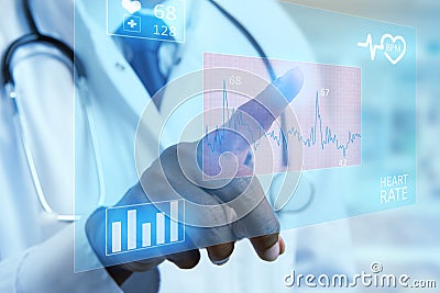 Close-up medic touching heart graph on display Stock Photo