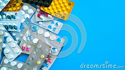 Close up of medical blister packs with tablets on blue background. Packs with various tablets. Concept of threat of Stock Photo