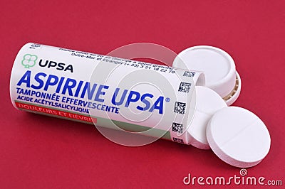Open aspirin pill tube close up on red background Editorial Stock Photo