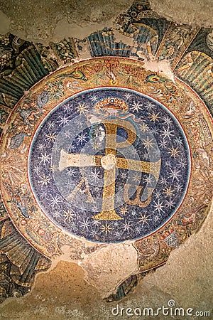 Close-up on medieval colorful mosaic in ruins showing GodÂ´s symbol for christians Stock Photo
