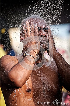 Close-up of men devotee having shower ritual in Thaipusam Festival. Editorial Stock Photo