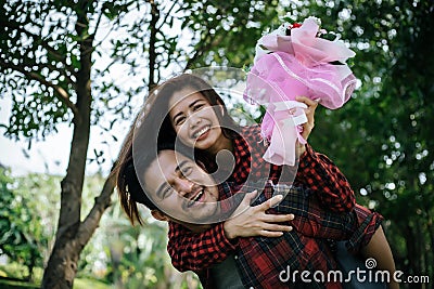 Close-up of a man giving happy woman flowers.A picture of a romantic couple Stock Photo