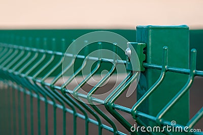 Close-up metal fence of green color welded from metal rods Stock Photo