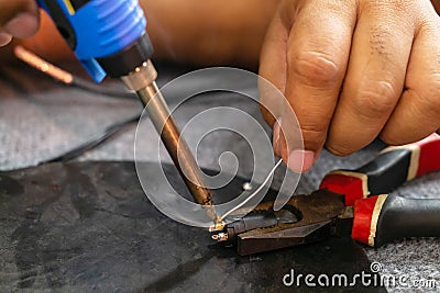 Close up of Microelectronics Engineering. Soldering Lead Repairing Microphone Wire Stock Photo