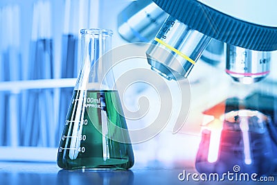 Close up microscope with lab glassware, science laboratory research and development. Stock Photo