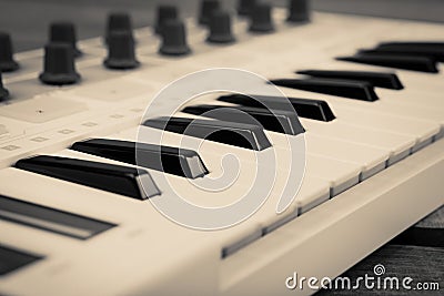 Close up of MIDI controller volume fader, knob and keys. Stock Photo