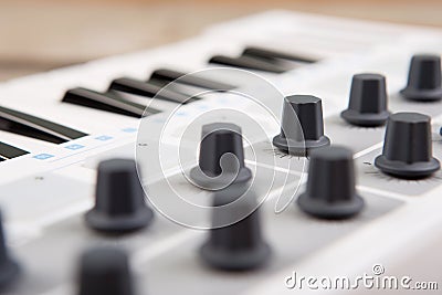 Close up of MIDI controller volume fader, knob and keys Stock Photo