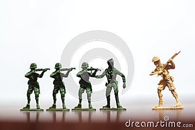 Close-up of miniature a group of plastic toys soldiers at war. Stock Photo