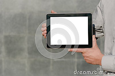 Close up, Mock up tablet, presentation of business plan, man hands. against the background of a concrete wall Stock Photo