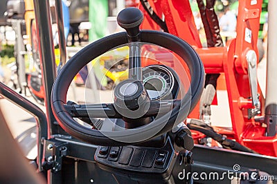 Close up of modern tractor steering wheel. Stock Photo