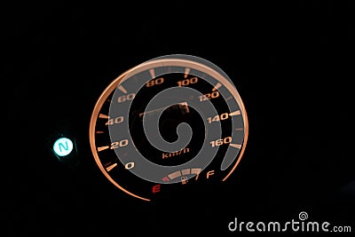 Close-up of motorcycle speedometer at night. Stock Photo