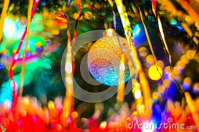 The close-up of the multi-colored Christmas toys in the form of a house, owl, horse on the Christmas tree in the new 2019 year. Stock Photo