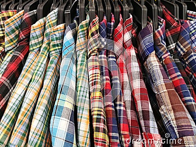 Close up Multicolor Grid pattern Shirts are hanging on Clothes Hanger Stock Photo