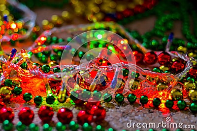 Close-up of multicolored Christmas beads for decorating the Christmas tree with a soft blurred background. Stock Photo