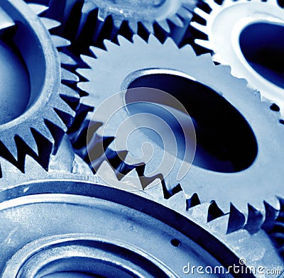 Close up of multiple blue cogs and gears on blue background Stock Photo