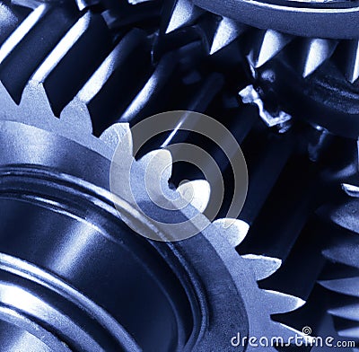 Close up of multiple blue cogs and gears on blue background Stock Photo