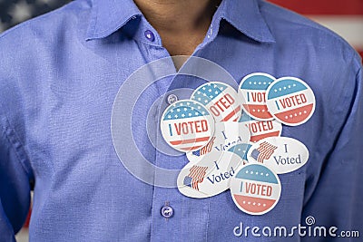 Close up of multiple I Voted stickers on blue shirt - Concept of US election voter fraud by placing multiple voting Stock Photo