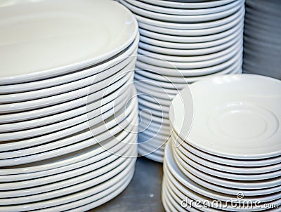 Close up of multiple stacks of white plates Stock Photo