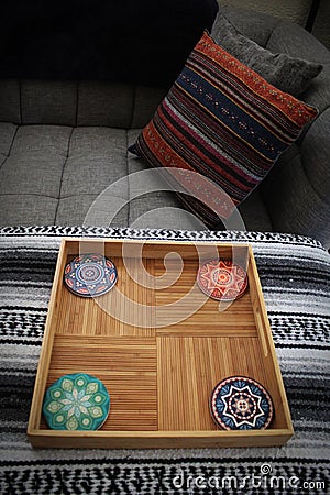 A close-up of of my orange throw pillow and coasters in a trays Stock Photo