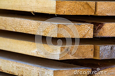 ; Close-up of neatly piled stack of natural brown rough wooden boa Stock Photo