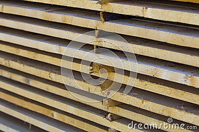 Close-up of neatly piled stack of natural brown rough wooden boa Stock Photo