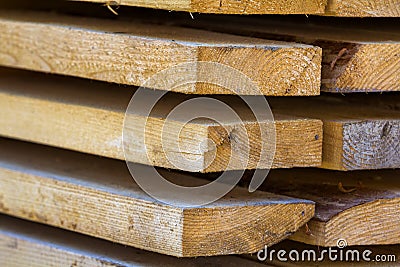 Close-up of neatly piled stack of natural brown rough wooden boa Stock Photo