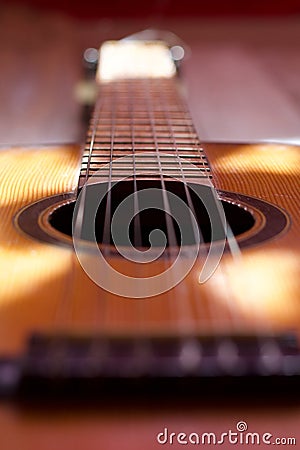 a close-up of the neck and strings of an acoustic guitar Stock Photo