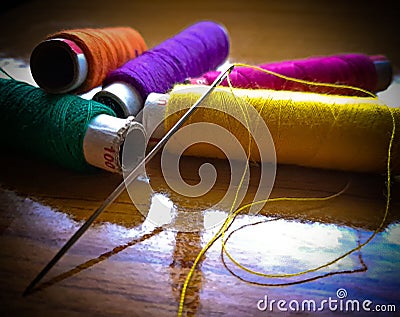 Close up of a needle thread and different color spools - the concept of sewing Stock Photo