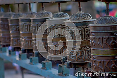 Close up of Nepalese religious carvings and prayer wheels at Swayambhu Temple also known as the Monkey Temple in Stock Photo