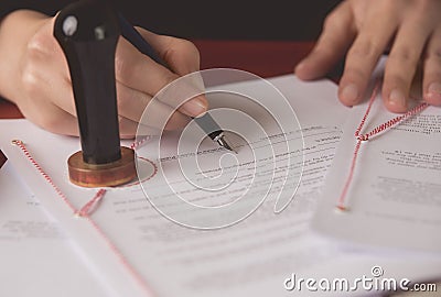 Close up on notaries public hand signing the testament Stock Photo