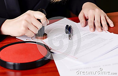 Close up on notaries public hand stamping the testament Stock Photo