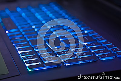 Close-up of notebook keyboard with blue light tint Stock Photo