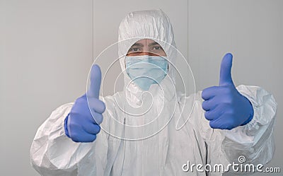 Close up of a nurse in a protective suit doing a thumbs up gesture. Covid 19 Stock Photo