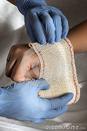 Close-up Of A Nurse Tying Bandage On Patient`s Foot Stock Photo