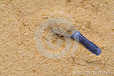 Flat lay full frame still life vegan nutritional yeast flakes with heaping stainless steel tablespoon Stock Photo