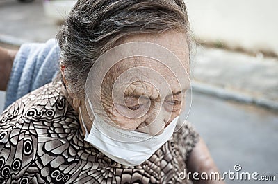 close-up of an octogenarian woman walking around in a wheelchair Stock Photo