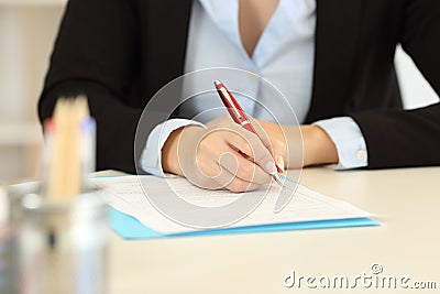 Close up of an office worker hands filling form Stock Photo