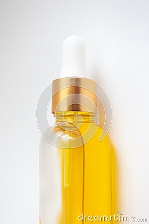 Close-up oil serum essence in glass bottle. Macro skincare product vertical photo Stock Photo