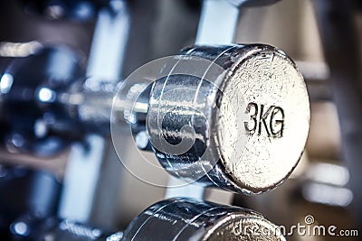 Old chrome 3kg dumbbell in a rack. Stock Photo