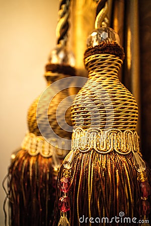 Close up old classic vintage gold tassels in warm light Stock Photo