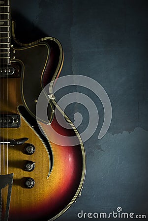 Close-up of old electric jazz guitar on a dark blue background Stock Photo