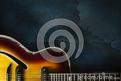 Close-up of old electric jazz guitar on a dark blue background Stock Photo