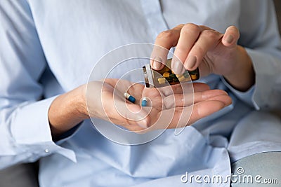 Close up old female hands pouring pills on palm Stock Photo