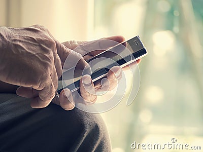 Close up of an old man is happy with typing mobile smart phone Stock Photo