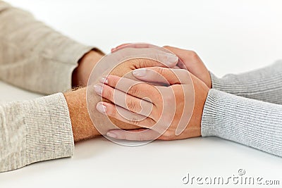 Close up of old man and young woman holding hands Stock Photo