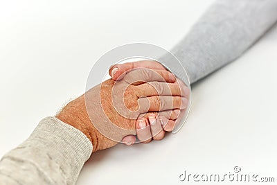 Close up of old man and young woman holding hands Stock Photo